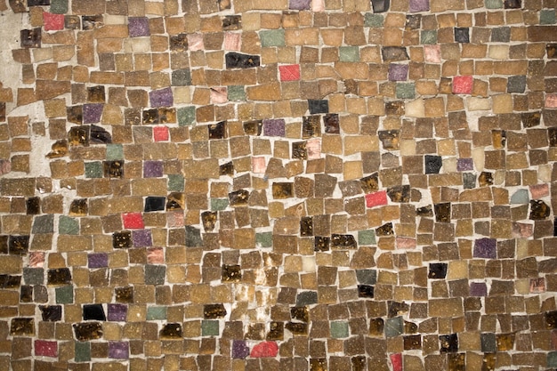 Concrete wall covered with colorful mosaic