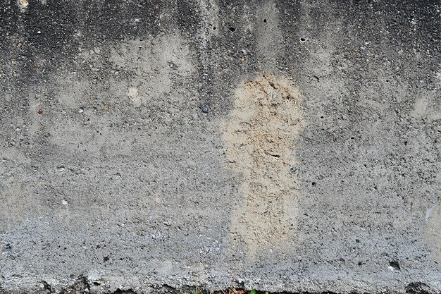 a concrete wall with a chipped paint on it