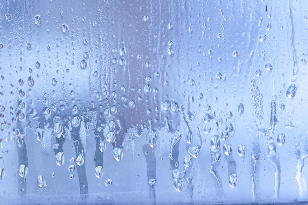 Condensation on the clear glass window Water drops Rain Abstract background texture Outside the window bad weather rain