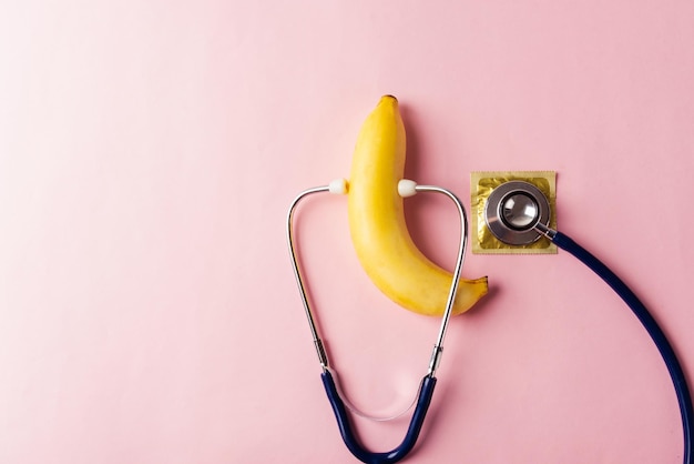 Condom in wrapper pack banana and doctor stethoscope