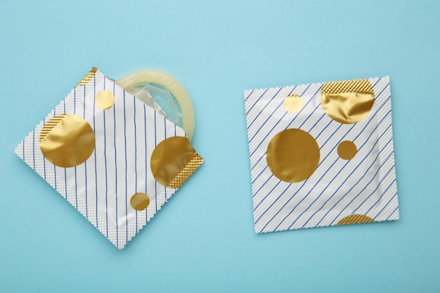 Condoms on blue background A condom use to reduce the probability of pregnancy or sexually transmitted disease