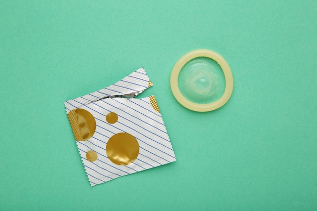 Condoms on mint background A condom use to reduce the probability of pregnancy or sexually transmitted disease