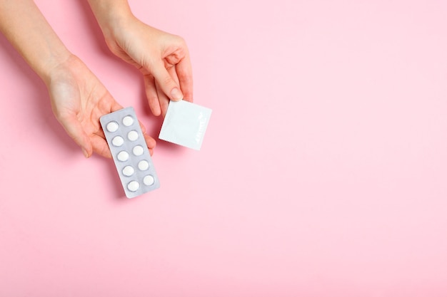 Condoms and other contraceptives on a colored background