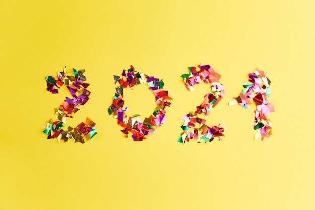 Confetti in 2021 shape on yellow surface