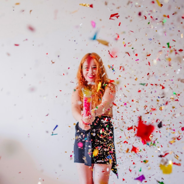 Confetti flying in air and girl behind