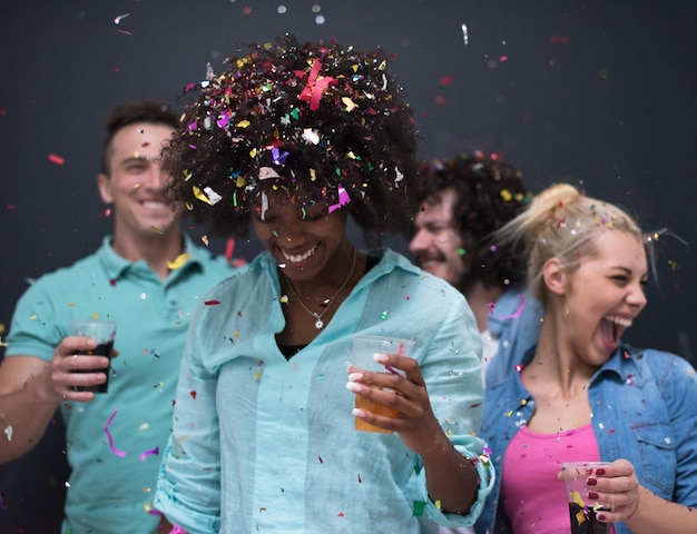 confetti party Multiethnics group of happy young people celebrating new year eve while dancing and have fun at home