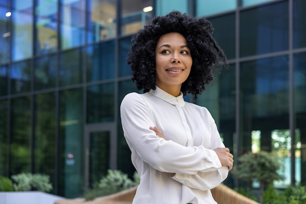 Confident adult mature businesswoman outside urban office business building african american boss