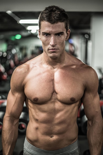 Confident athlete man in gym