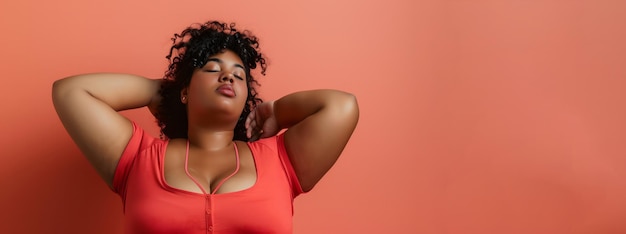 Confident black woman posing against a coral background body positive concept