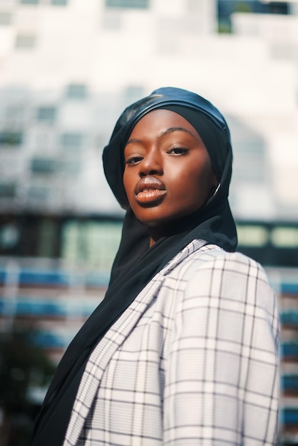 Confident black woman in traditional headscarf and formal wear