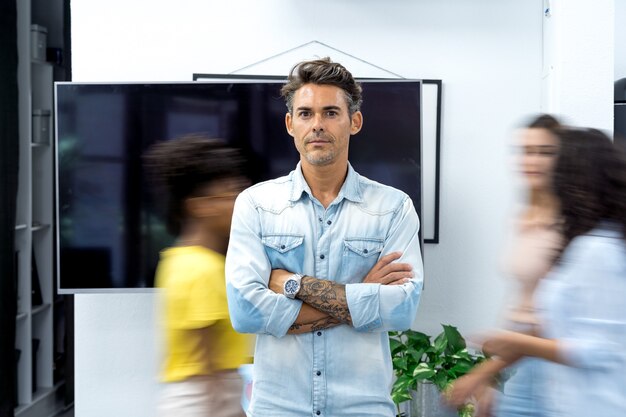 confident business man standing in modern office