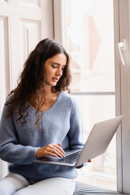 Confident business woman is chatting using laptop with colleagues via video connection and discussing new ideas and deadline Happy girl with laptop is chatting with her friends and family in cafe