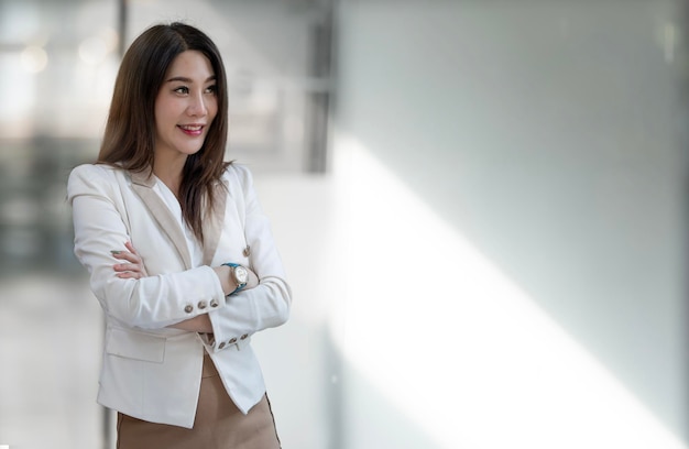 Confident business woman standing in the office with copy space