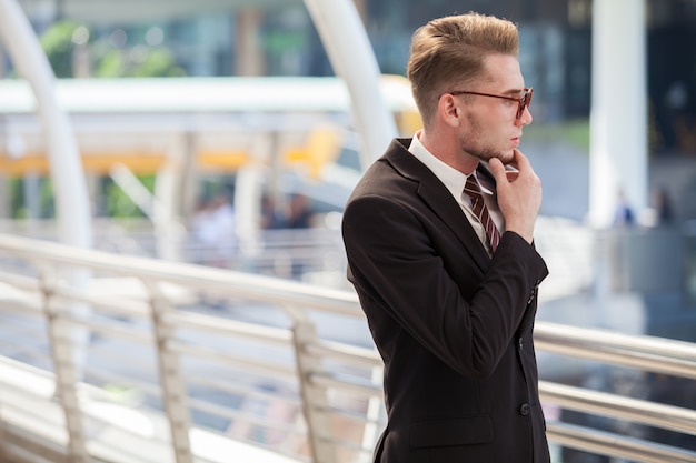 Confident businessman. Confident young man in full suit looking away