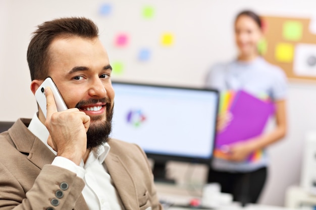 confident businessman and his assistant in the office