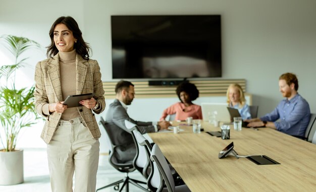 Confident businesswoman leading a strategic meeting in a modern office at midday