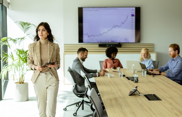 Confident businesswoman leading a strategic meeting in a modern office at midday