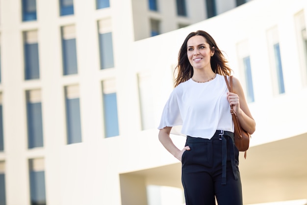 Confident businesswoman standing outside an office building.