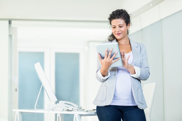 Confident businesswoman using digital tablet