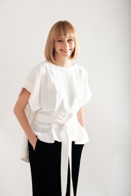 Confident businesswoman in white formal suit on background