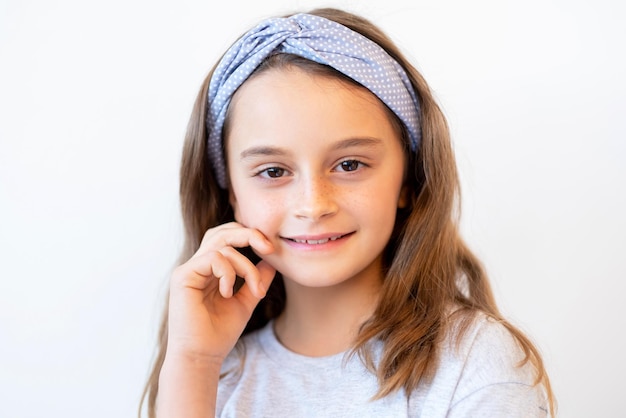 Confident child portrait. Positive attitude. Inspiration motivation. Enthusiastic proud smart cheerful brunette little girl face looking at camera isolated on light background.