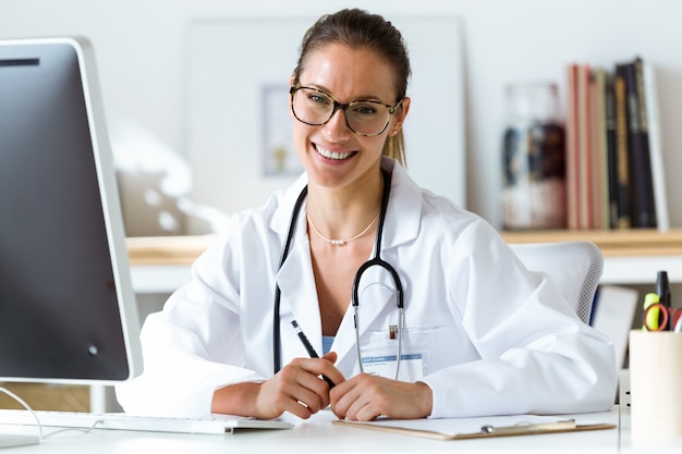 Confident female doctor in the office looking at camera.