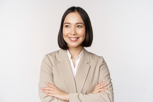 Confident female entrepreneur asian business woman standing in power pose professional business person cross arms on chest standing over white background