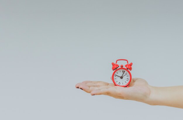 Confident Friendly Young Caucasian Woman Holding A Large Clock In Hands Showing The Success And Joy Of Good Office Timekeeping In A Happy Hour Concept