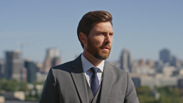 Confident gentleman posing street in elegant suit close up portrait businessman