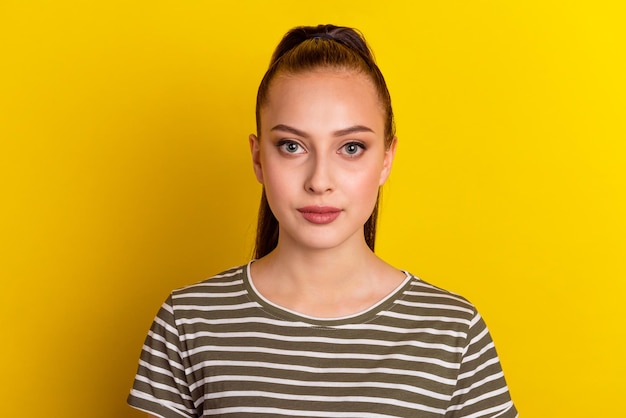 Confident goodlooking beautiful woman with healthy pure skin dressed in casual clothes looking seriously at camera