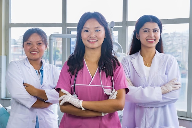 Confident Group of Nepali Indian Nurse and Doctors Smiling with hands crossed in a Dental Hospital