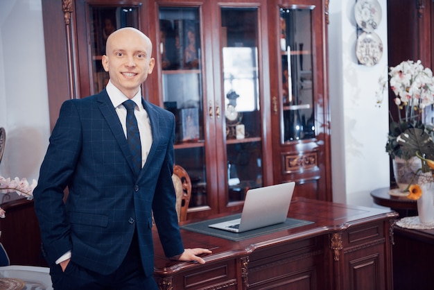 Confident handsome businessman sitting in luxury interior