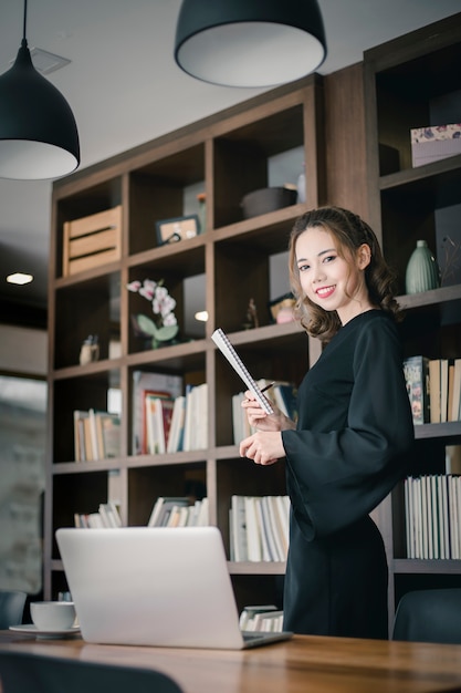 Confident happiness young woman working on laptop or notebook in her office.