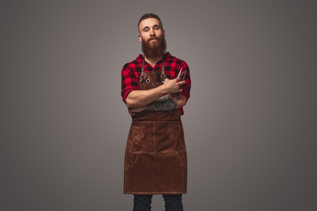 Confident male barber with scissors