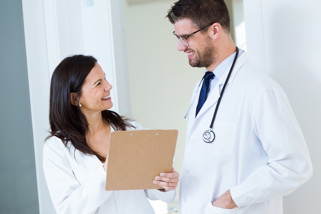 Confident male doctor and his nurse working in the office.