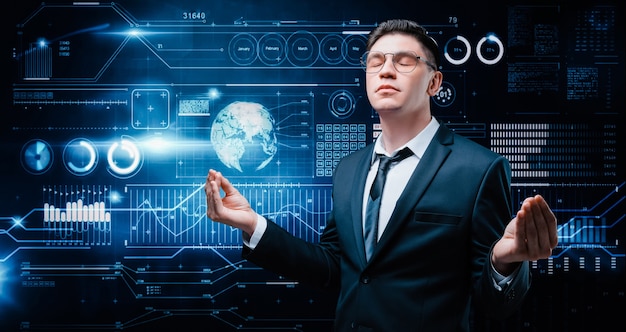 Confident man is standing in a business suit on the background of a stock exchange hologram. He is meditating. Stock broker and trader. Business investment. 