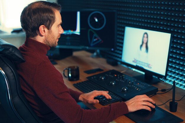 Confident Man Video Editor Works with Footage in Creative Office Studio.