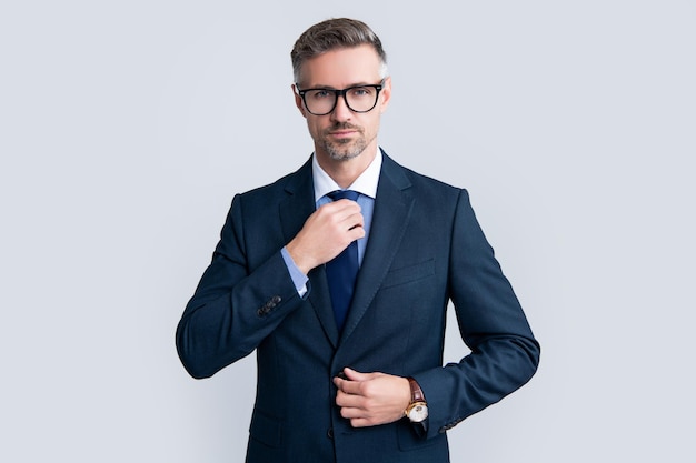 Confident mature businessman in businesslike suit and glasses