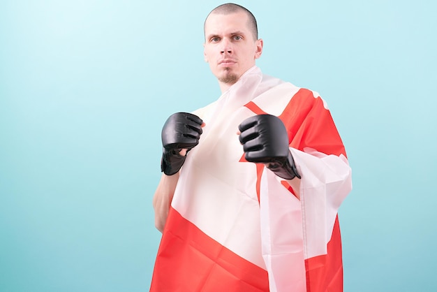 A confident MMA fighter in black gloves and a Canadian flag ready to fight on a blue background Fighting stance Pose Knockout Bald Mixed Martial Arts Hit Heavy Tough Hitting Win Goal