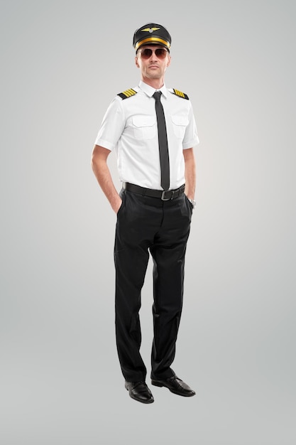 Confident pilot in uniform in studio