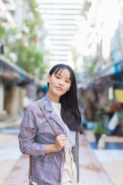 Confident professional young Asian business woman she commute to work through the old town.