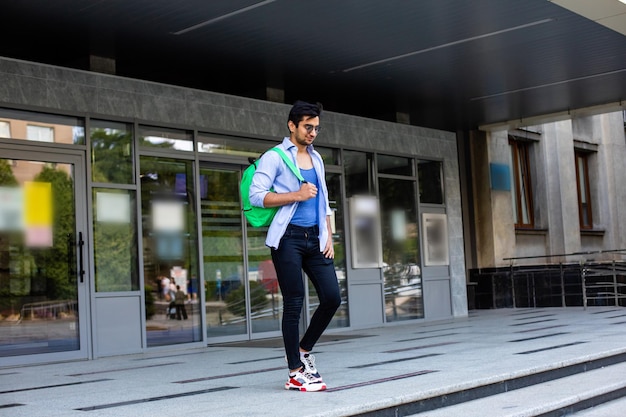 The confident student leaves the university building