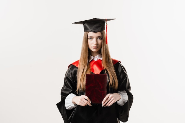 Confident student with diploma in graduation robe and cap ready to finish college Future leader of science Academician young woman in black gown smiling