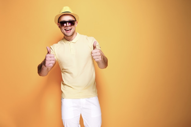 Confident stylish guy showing thumb up