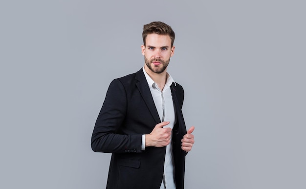 Confident and stylish sexy ceo on gray background modern office life charismatic business owner stylish realtor handsome man wear formal suit confident businessman in shirt jacket boss male