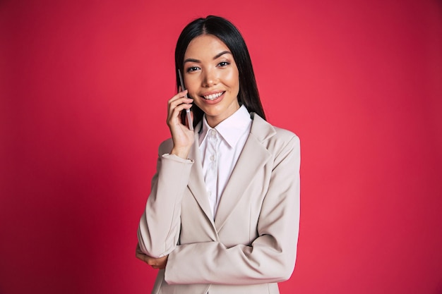 Confident success asian business woman is talking on the phone with client