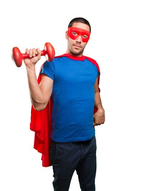 Confident superhero with a dumbbell