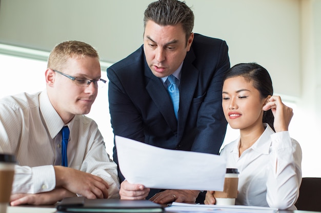 Confident team discussing project at meeting