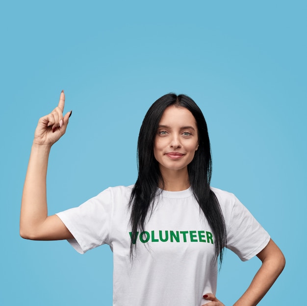 Confident volunteer pointing up