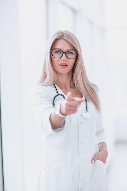 Confident woman doctor diagnosing pointing at you